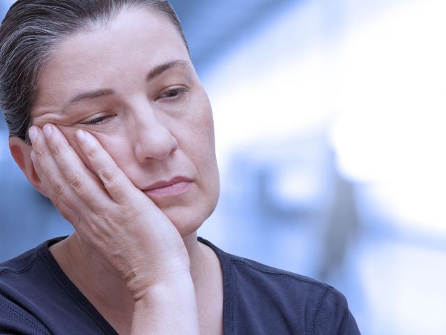 Tired woman showing the affect of sleep apnoea