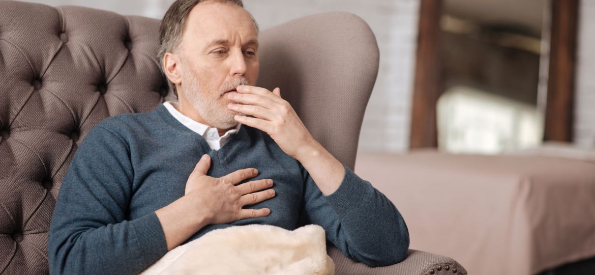 a man coughing to help explain what is COPD