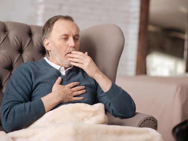 a man coughing to help explain what is COPD